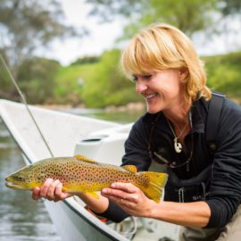 Lady gently cradling a brown trout just prior to release
